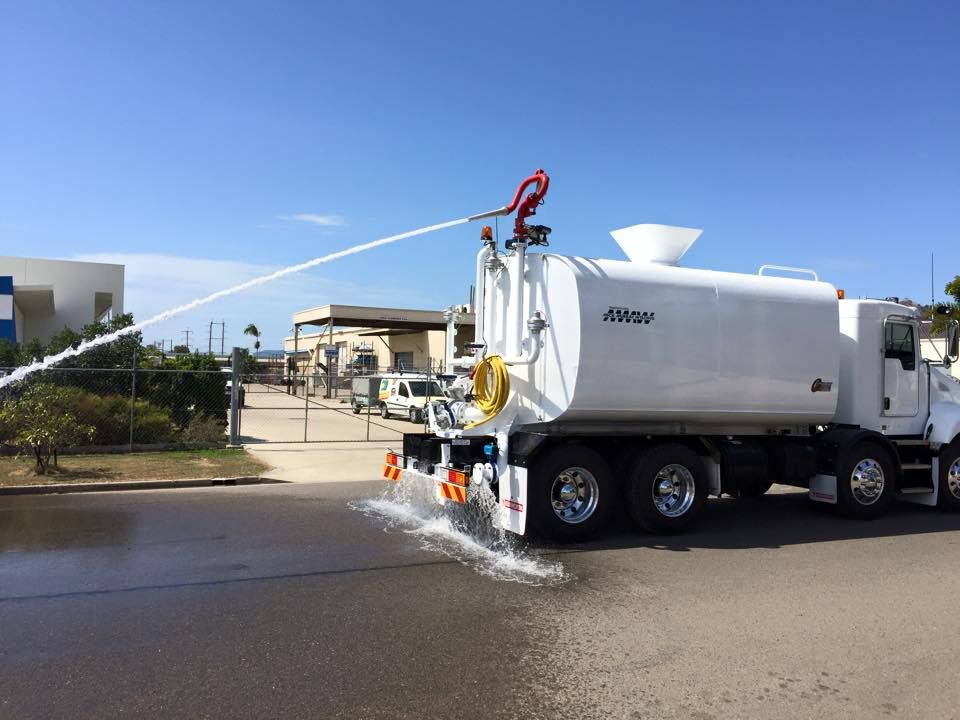 A White Water Truck Spraying Water on A Street — Aust. Advanced Trailer Sales & Service in Berrimah, NT