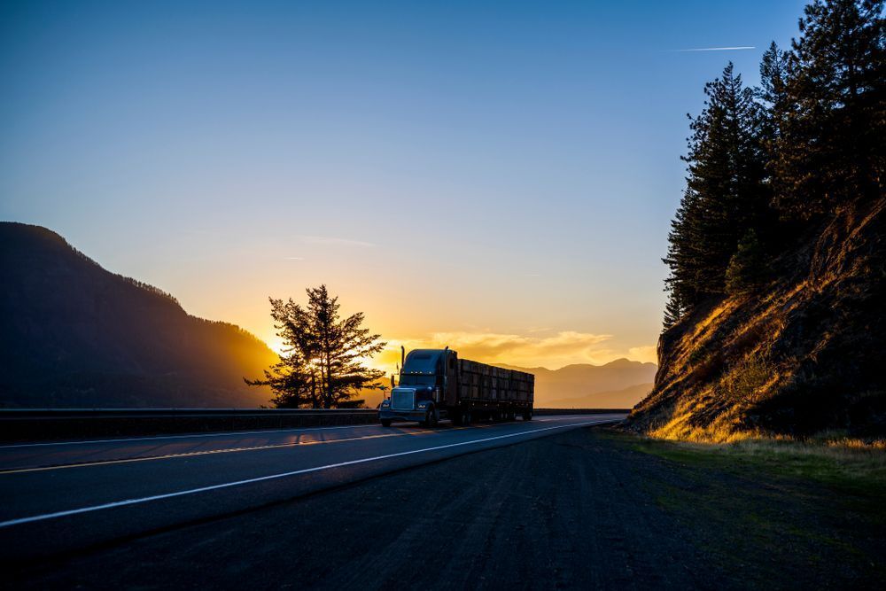 A Semi-Truck Drives on Highway at Sunset — Aust. Advanced Trailer Sales & Service in Tiwi Islands, NT
