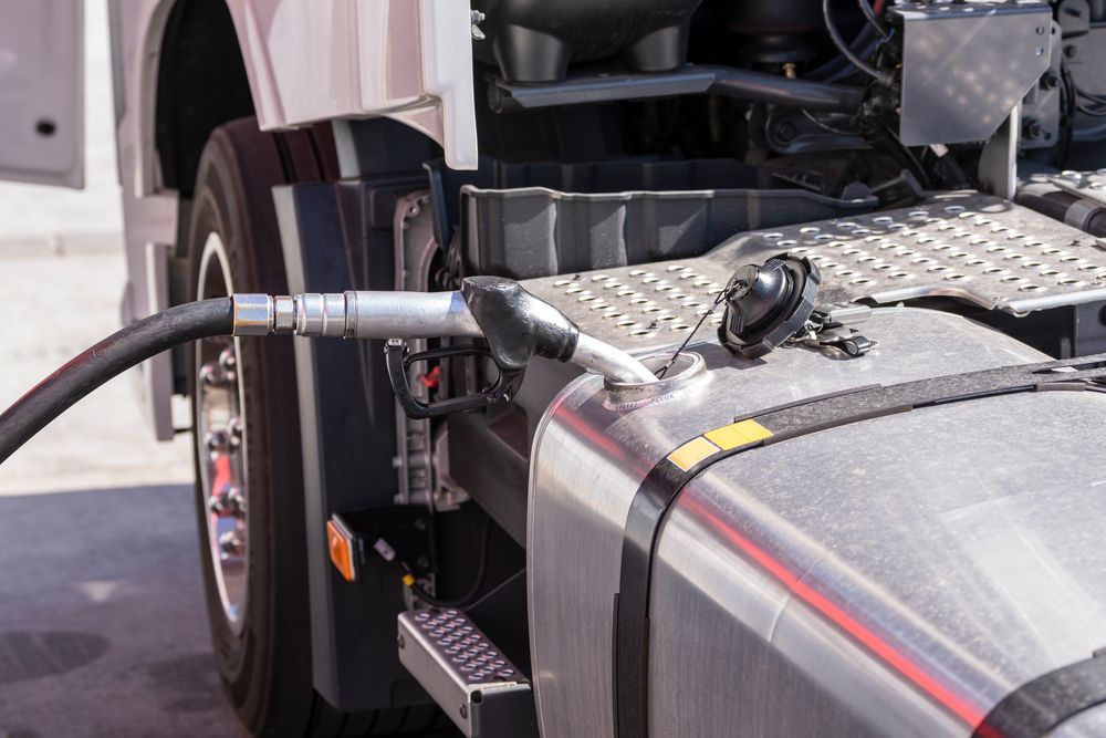 A Fuel Nozzle Inserted Into a Silver Truck Fuel Tank — Aust. Advanced Trailer Sales & Service in Berrimah, NT