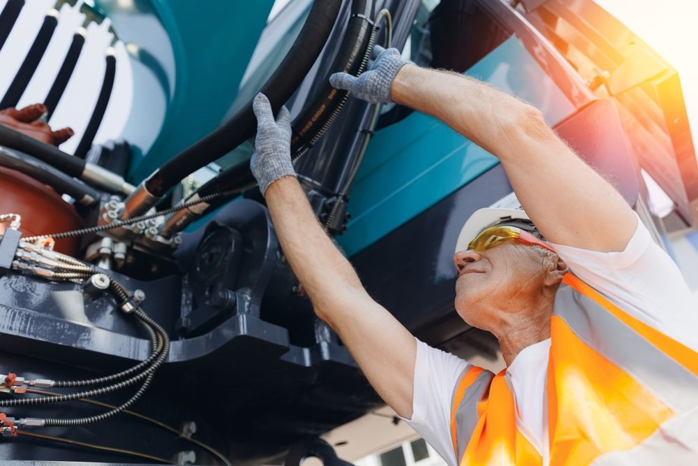 A Construction Worker in Safety Vest Inspects Machinery — Aust. Advanced Trailer Sales & Service in Berrimah, NT
