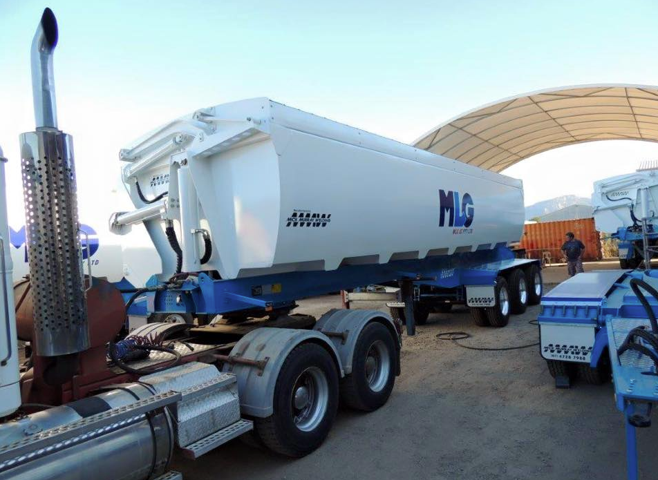 White and blue MLG bulk trailer hitched to a truck, parked outdoors — Aust. Advanced Trailer Sales & Service in Berrimah, NT