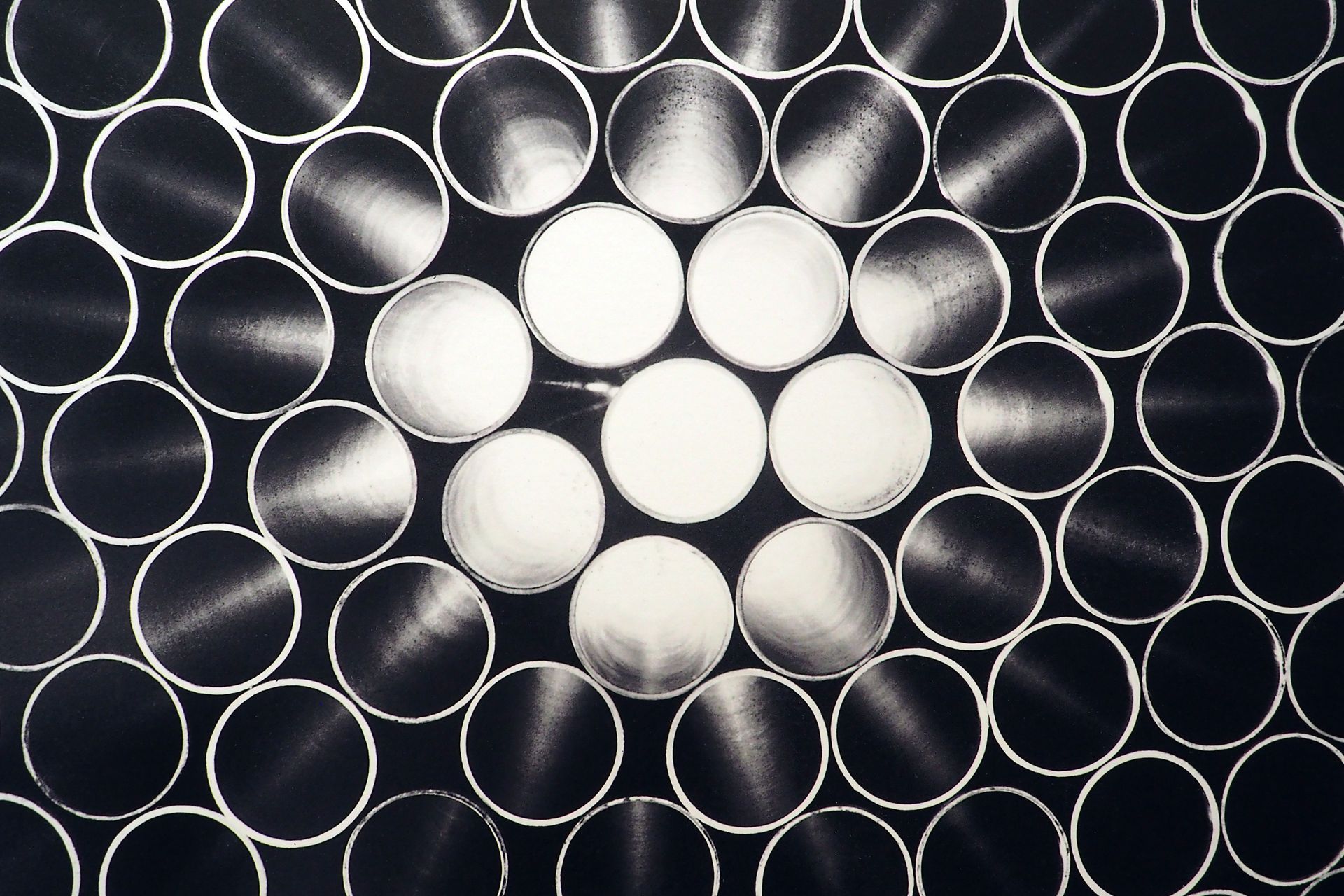 Top view of metal pipes arranged in a circular pattern.