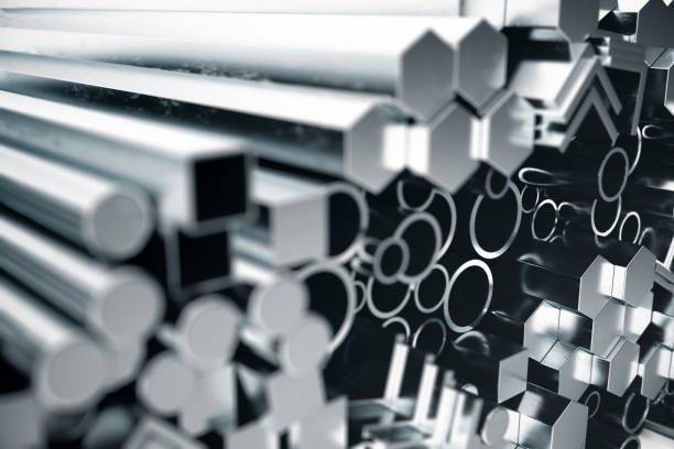 Close-up of stacked metal bars and tubes, aluminum and steel profiles for industrial manufacturing