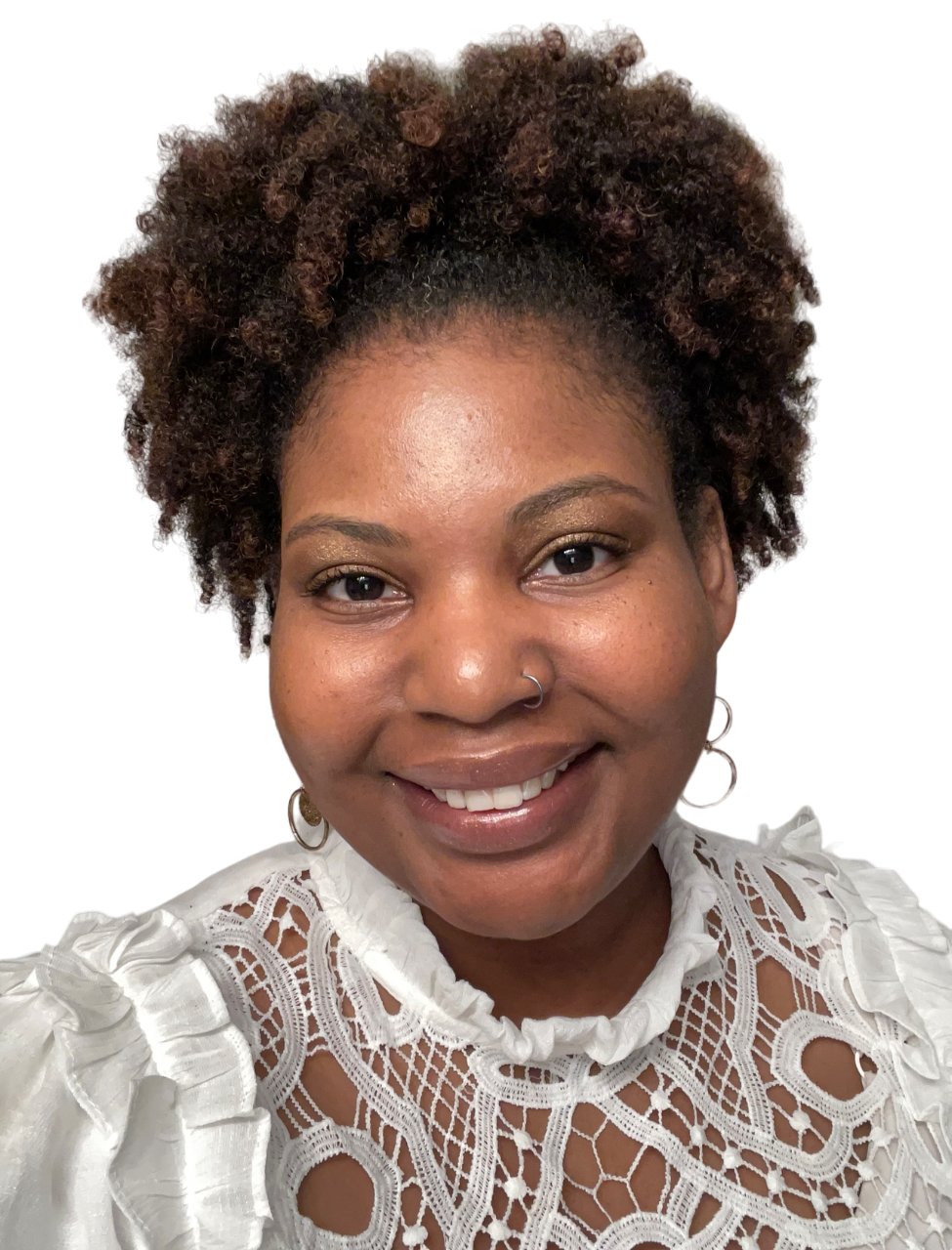 A woman with curly hair is wearing a white lace top and smiling.