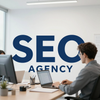 Person working at a desk in an office with a large “SEO AGENCY” sign on the wall.
