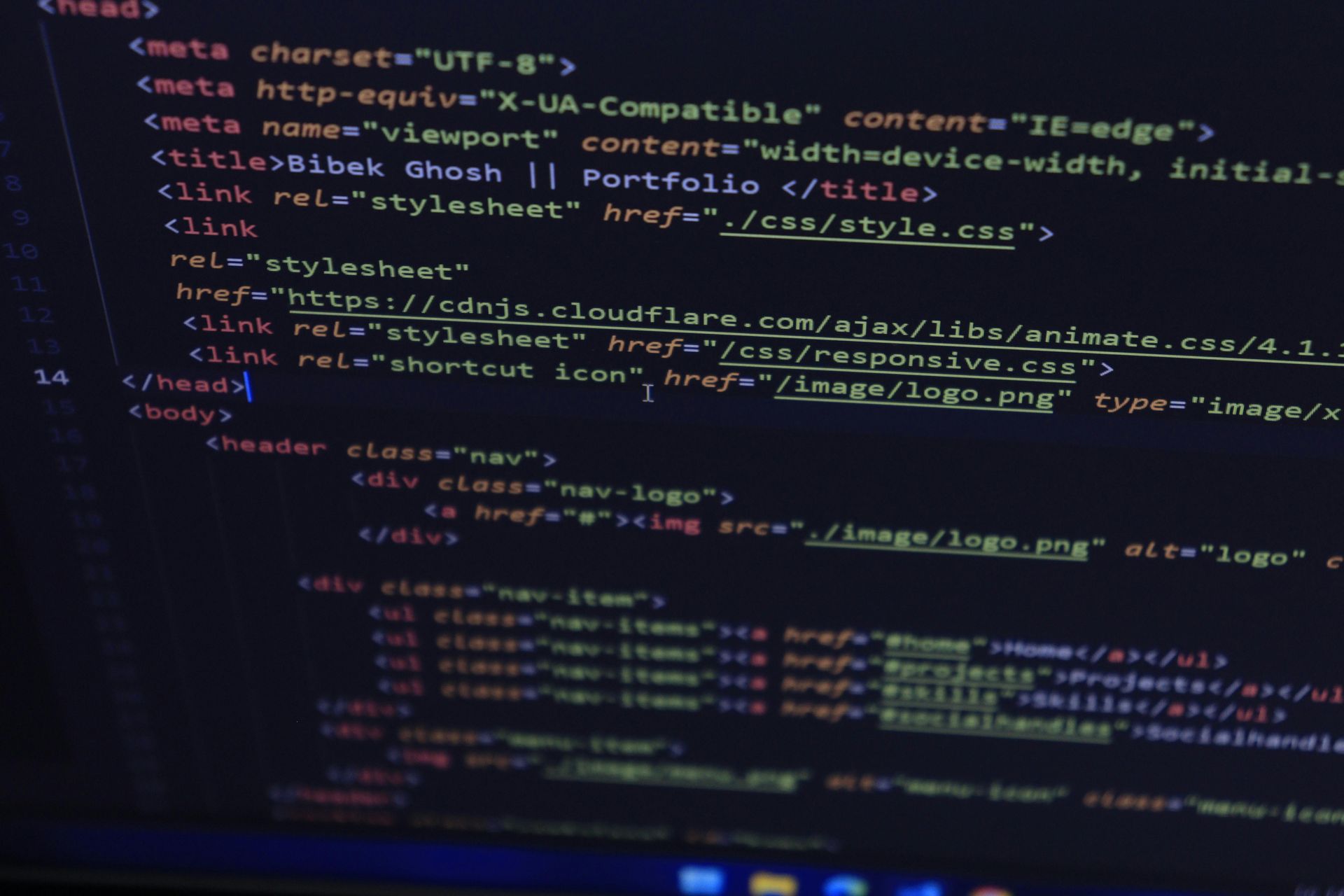 Close-up of a dark-themed computer screen showing HTML/CSS code in a code editor