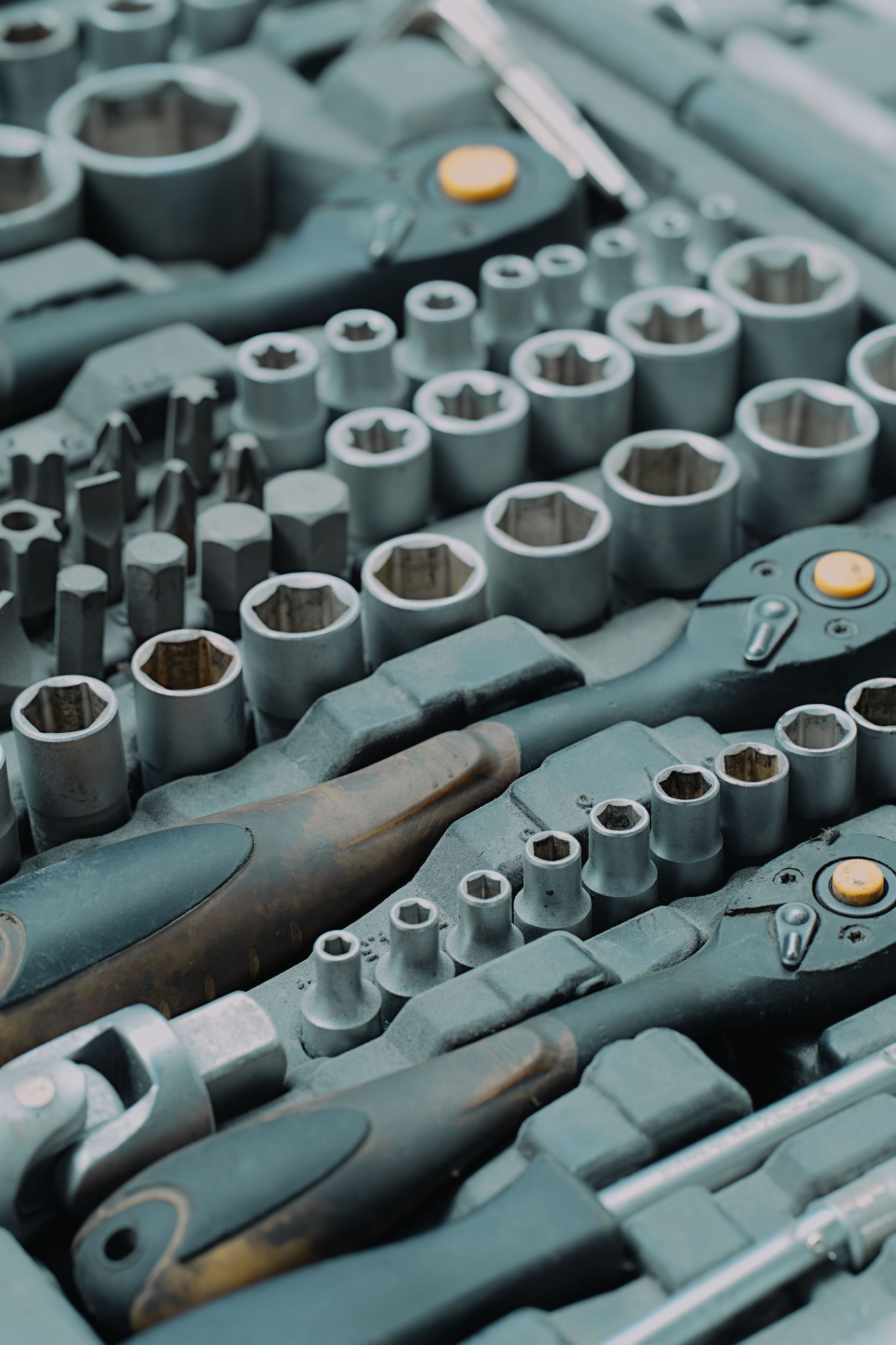 Close-up of socket wrench sets with metal sockets and ratchets in a toolbox