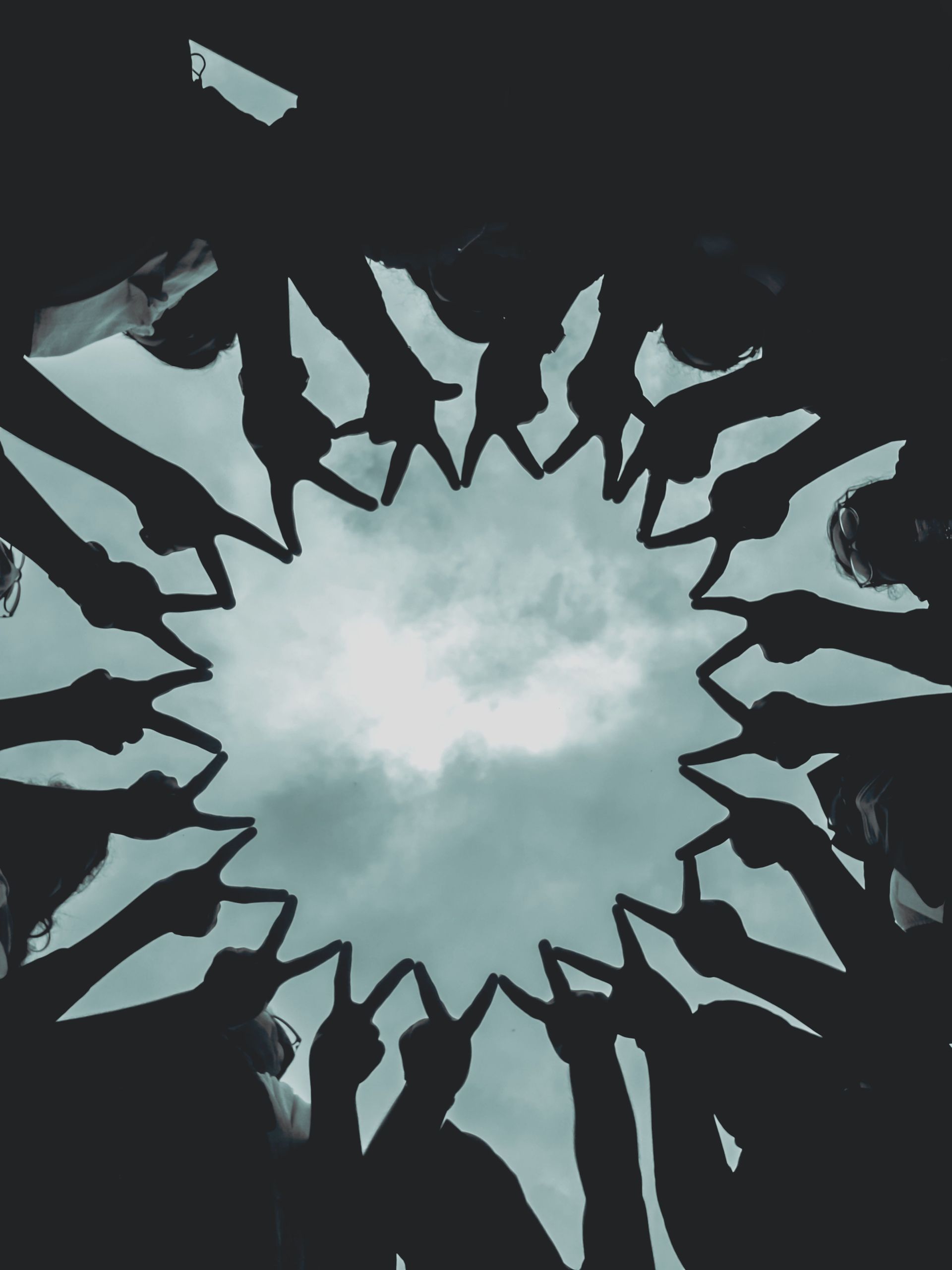 White light burst framed by dark, jagged shards radiating outward against a black background