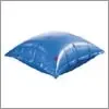 A blue pillow is sitting on top of a white surface.