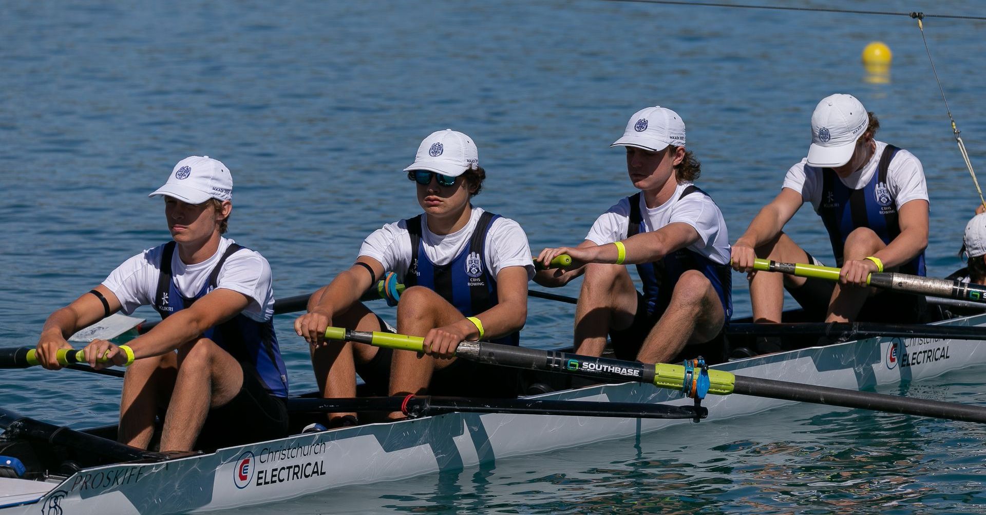 CBHS rowing team in boat sponsored by Christchurch Electrical.