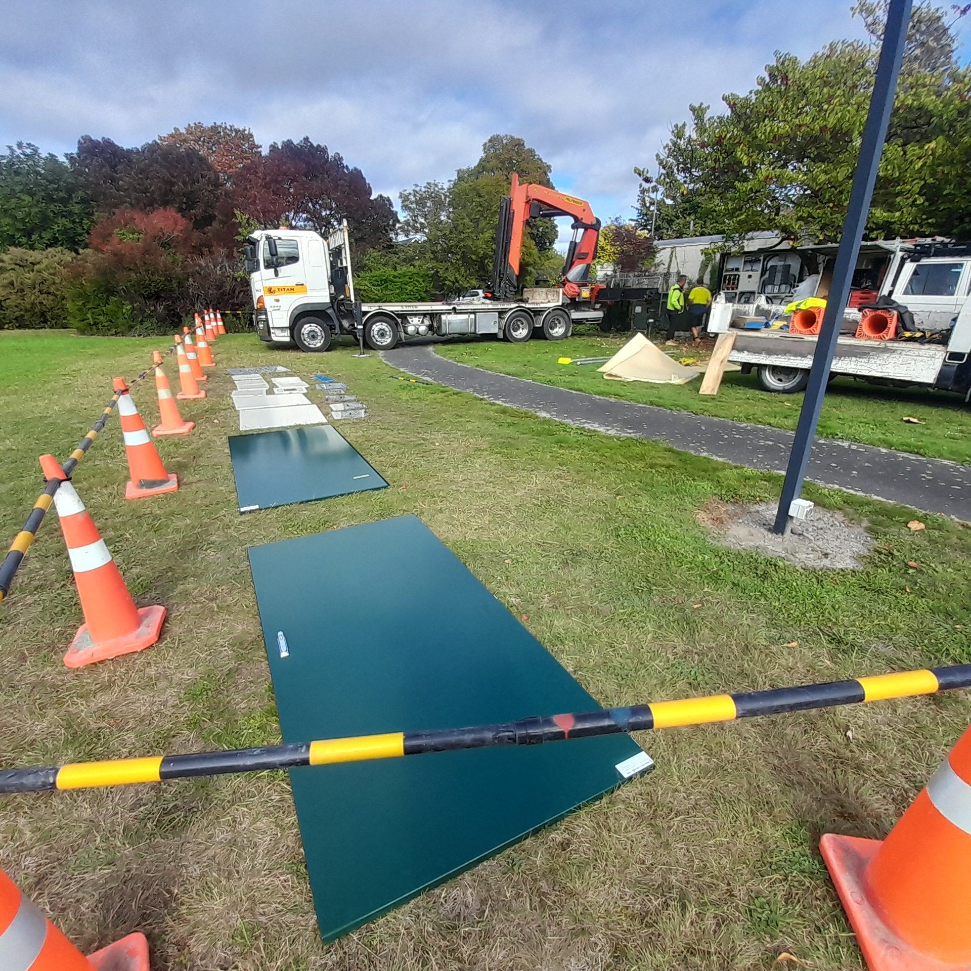 Cones and barriers with switchboard doors laid out on the grass.
