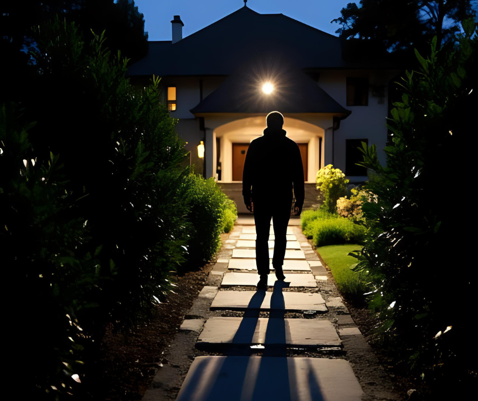 Dark Shadow Walking Away From House With Security Lighting