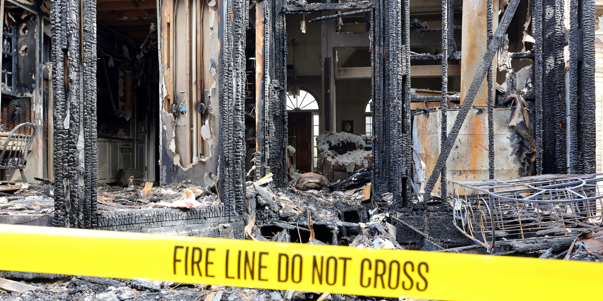 House after fire with Fire Line Do Not Cross tape