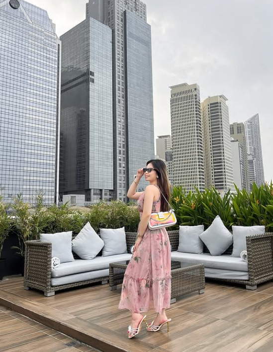 Woman in pink floral dress on rooftop terrace at The Belamy House Makati