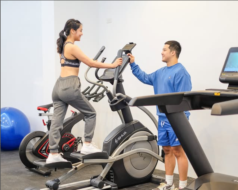 Guests enjoying the Makati hotel fitness center with stationary bikes for exercise