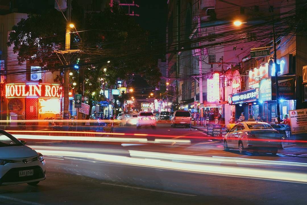 Vibrant nightlife street scene in Makati near hotels in Poblacion area.