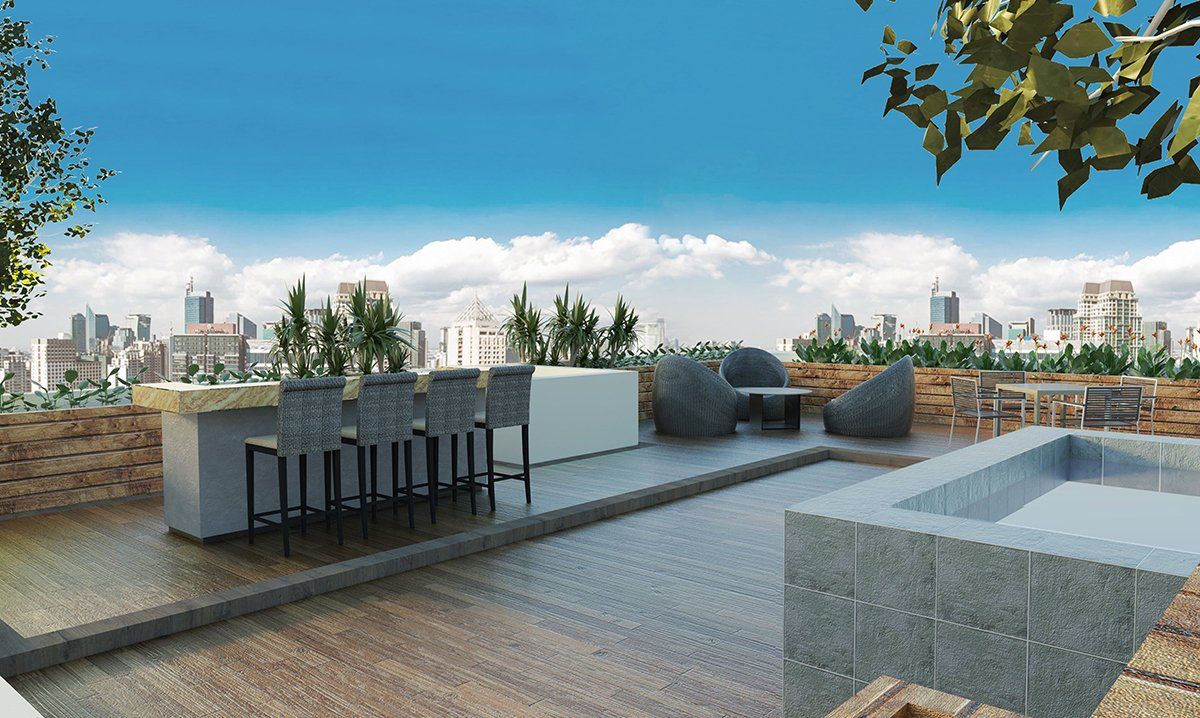 Rooftop pool and bar lounge with city skyline views at The Belamy House Mak