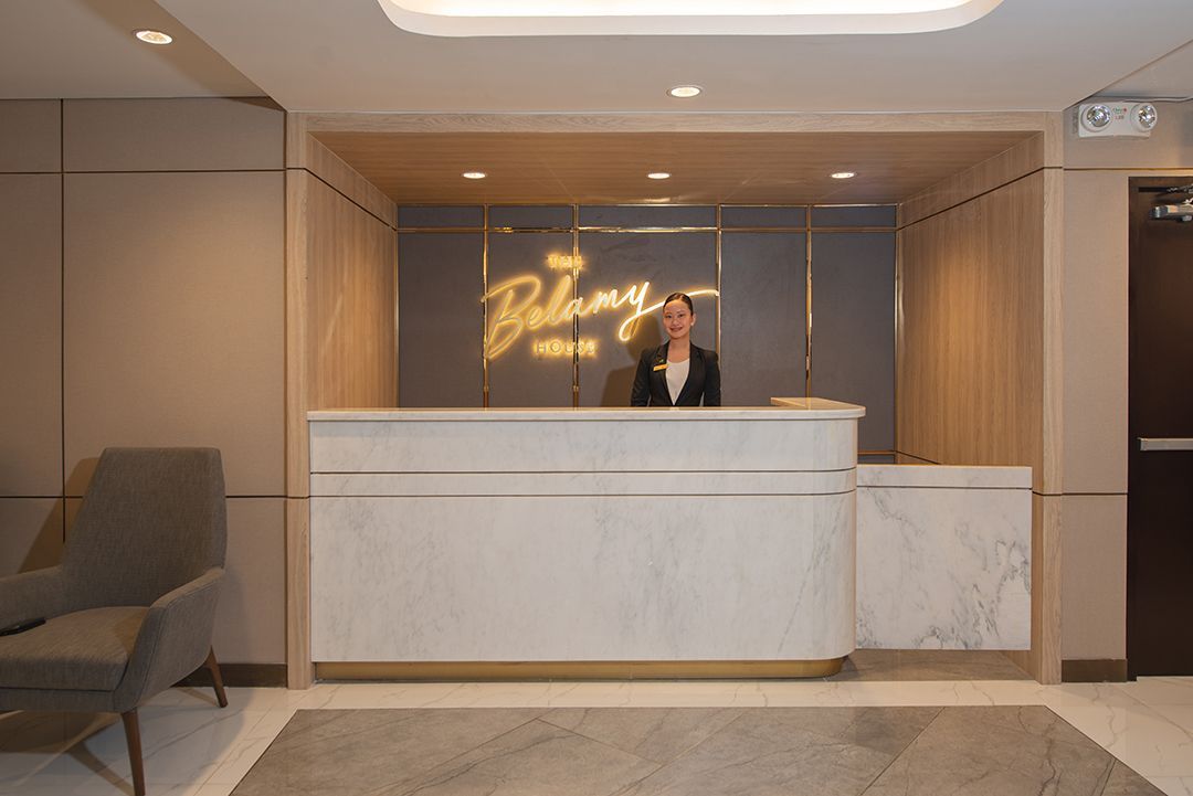 The Belamy House hotel reception desk with smiling front desk staff
