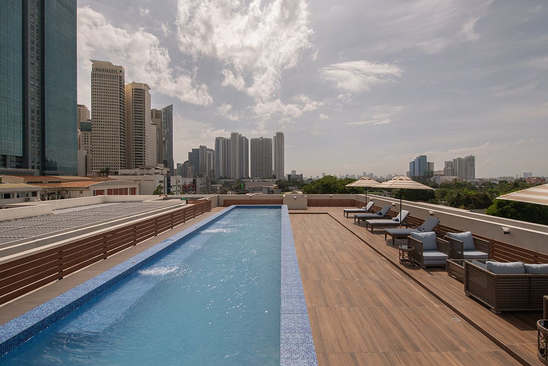 Rooftop infinity pool with city skyline views at The Belamy House Makati