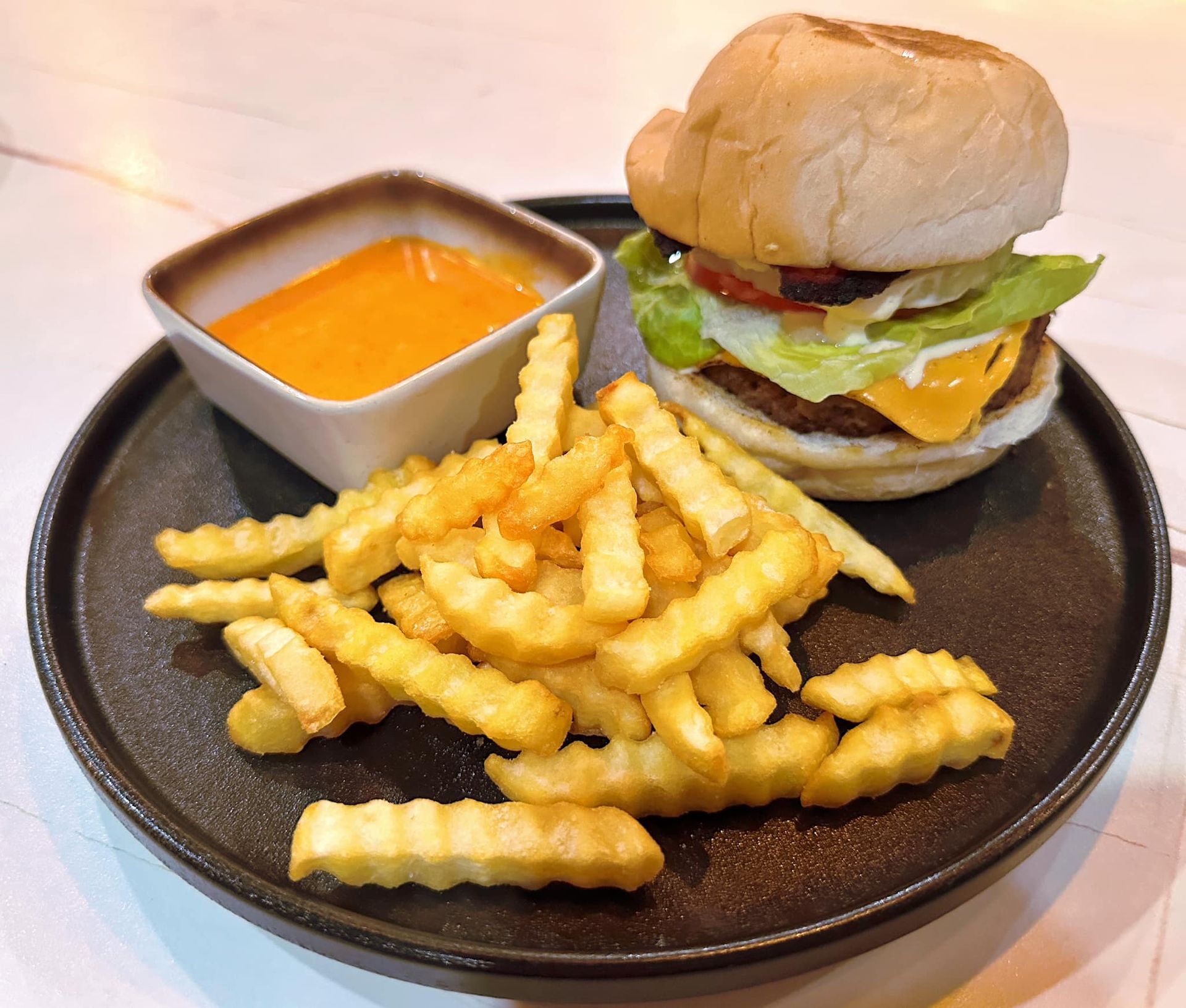 Cheeseburger with crinkle fries and dipping sauce at The Belamy House Makat