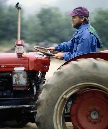 Man Driving Tractor — Spartanburg, SC — Carolina Hose & Hydraulics, Inc. Man Driving Tractor — Spartanburg, SC — Carolina Hose & Hydraulics, Inc.