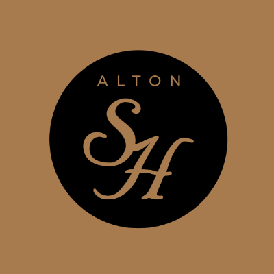 A black and gold logo for alton sh