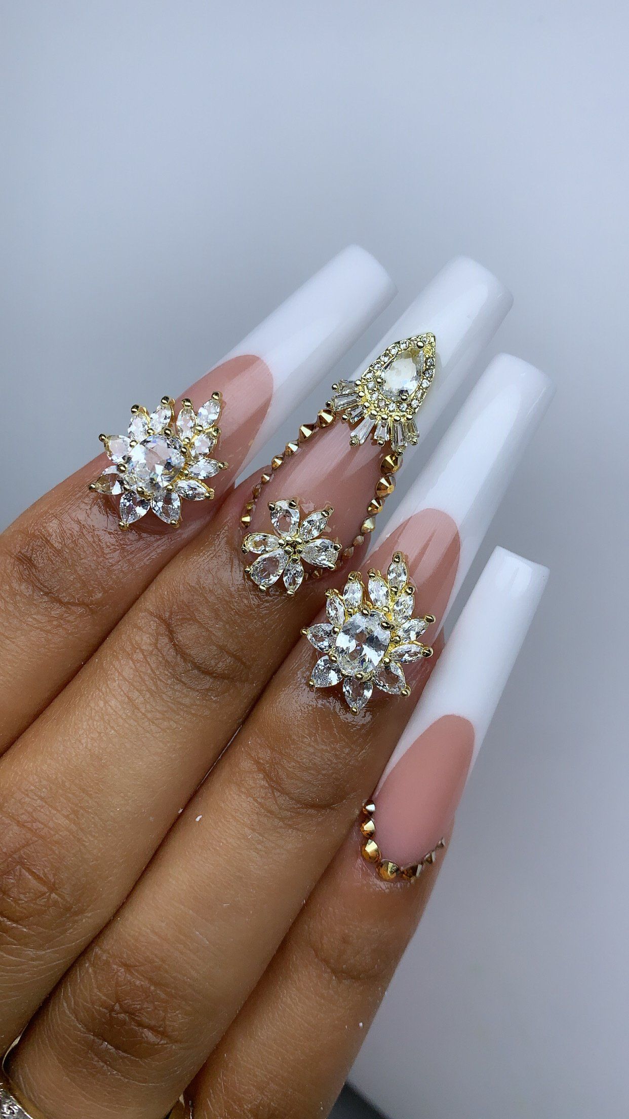 A close up of a person 's nails with rhinestones on them.