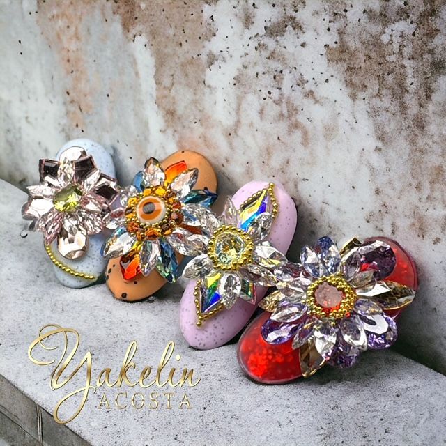 A bunch of flowers are sitting on a concrete surface with the word yakelin on the bottom
