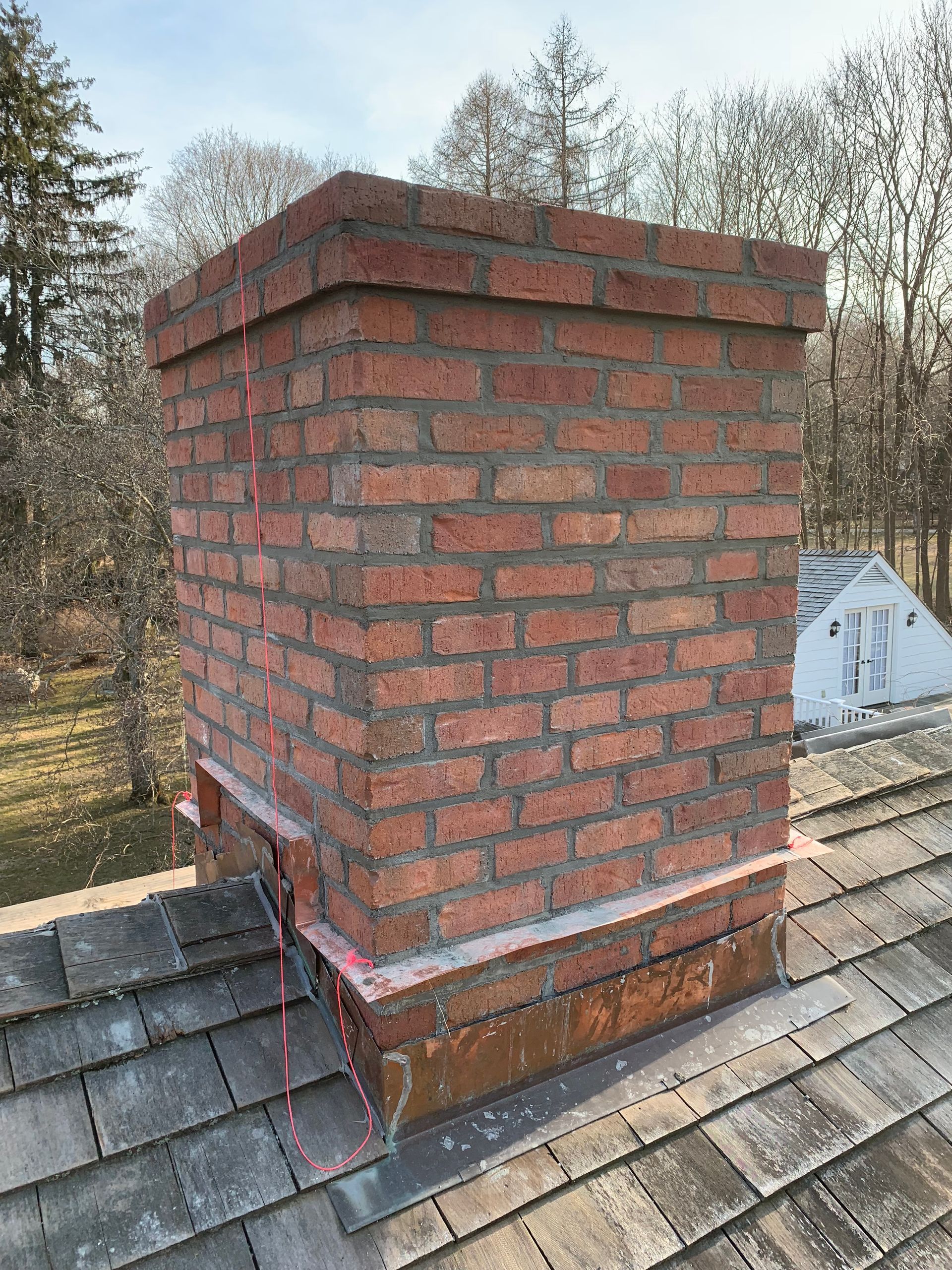 Brick chimney rebuild cedar roof CT by Executive Homes LLC