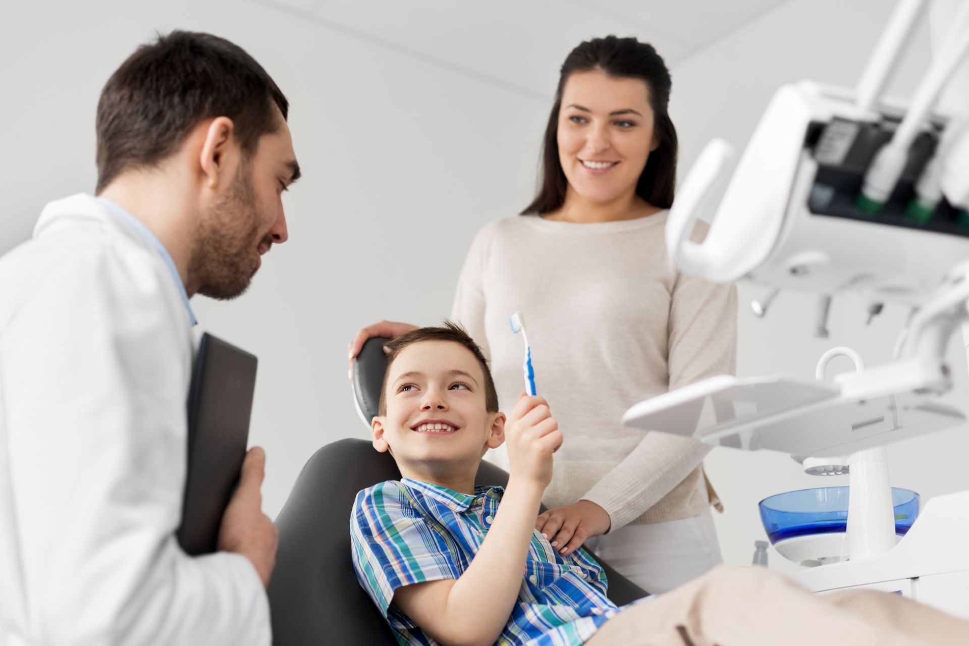 Family dentist providing dental care for a child during a family visit