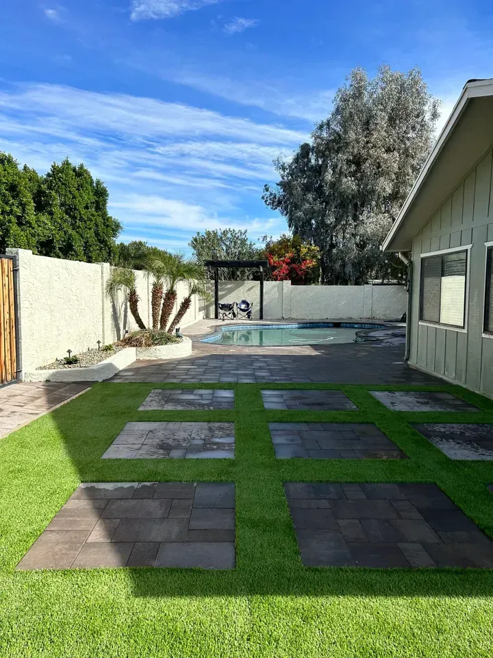 There is a swimming pool in the backyard of a house.