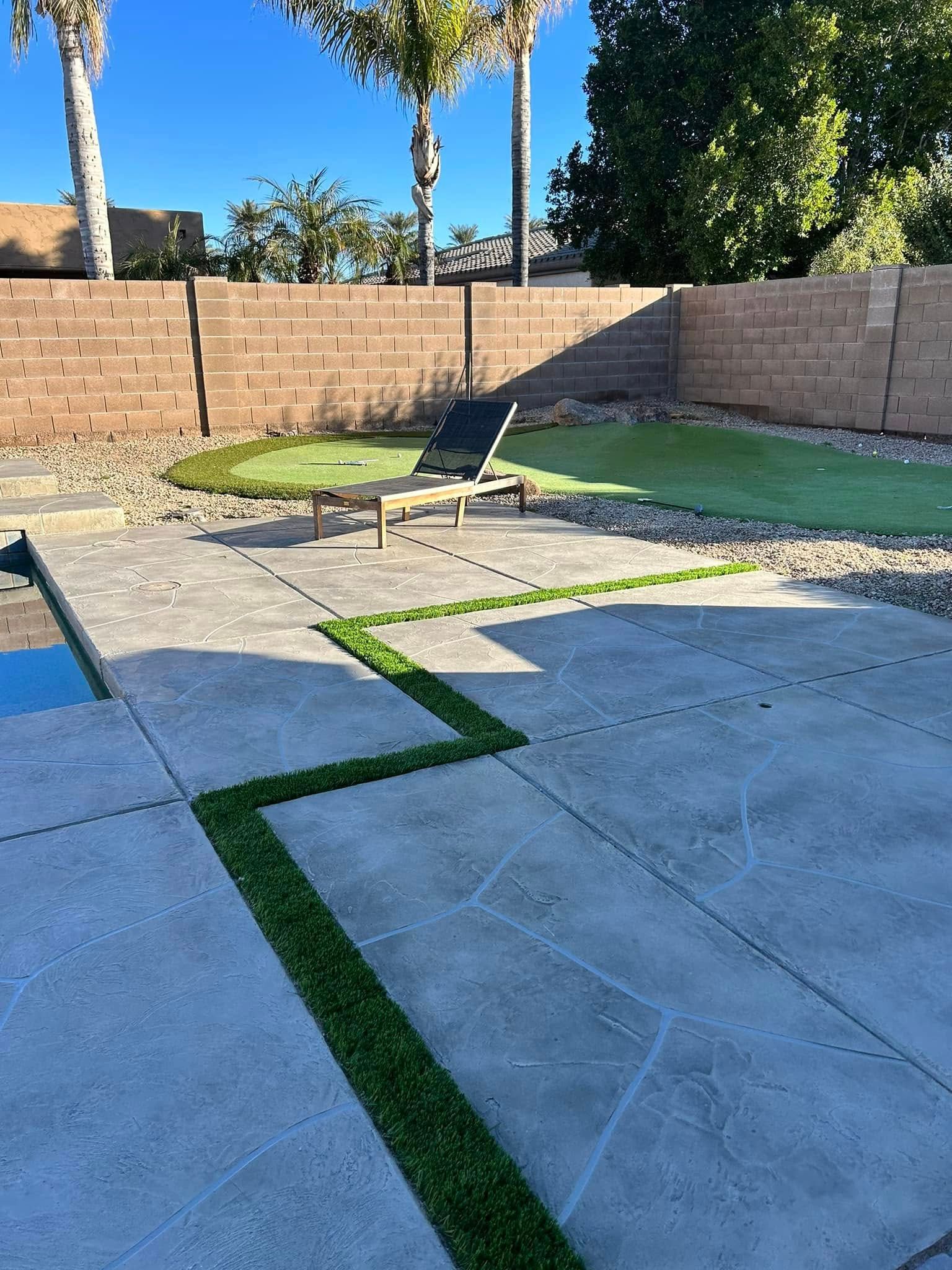 A patio with a lawn chair and a pool in the background.