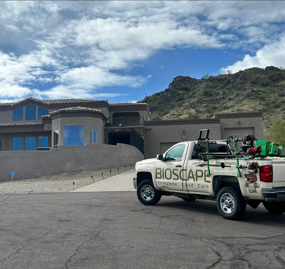 A bioscape truck is parked in front of a house