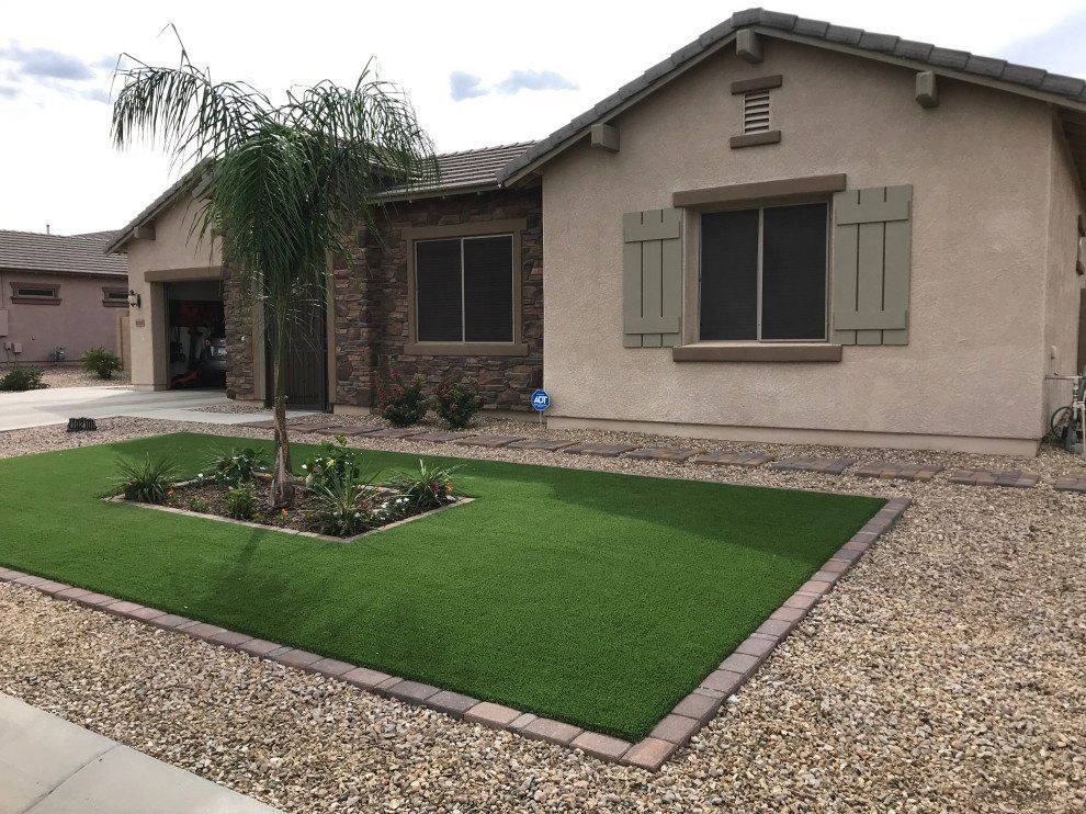 A house with a lush green lawn in front of it.
