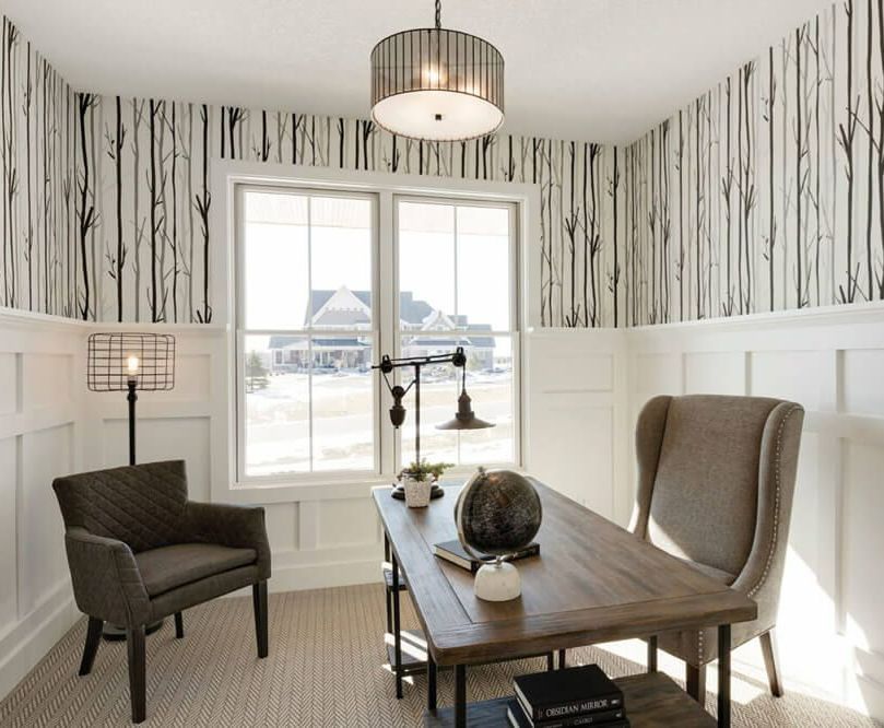 A home office with a wooden desk and chairs