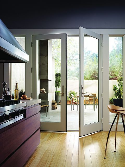 A kitchen with stainless steel appliances and wooden cabinets