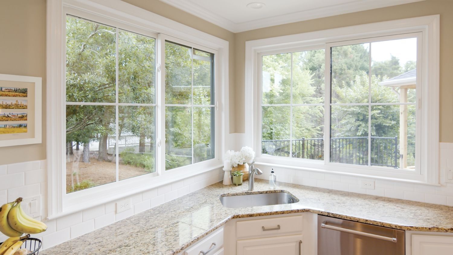 A kitchen with a sink and a lot of windows.