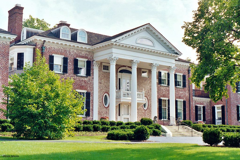 A large brick building with a porch and columns