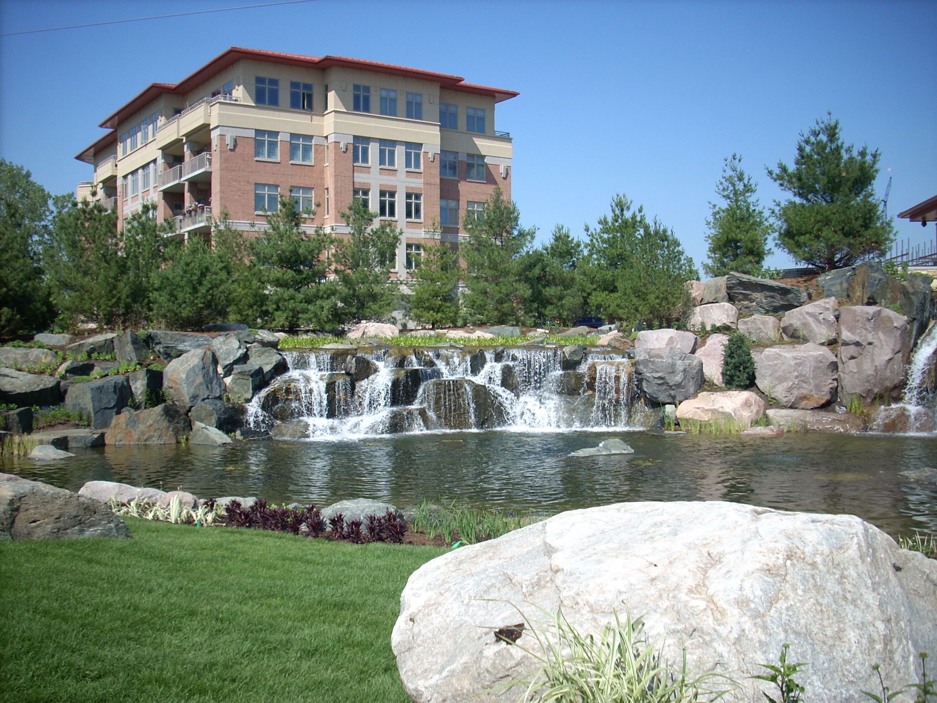 A large building with a waterfall in front of it