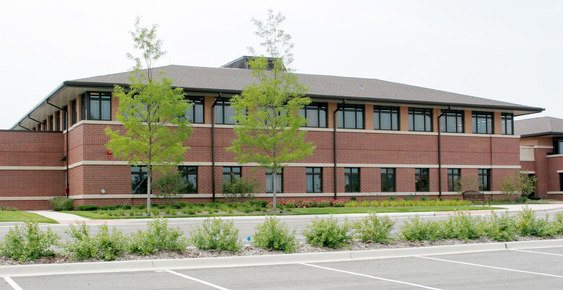 A large brick building with a parking lot in front of it