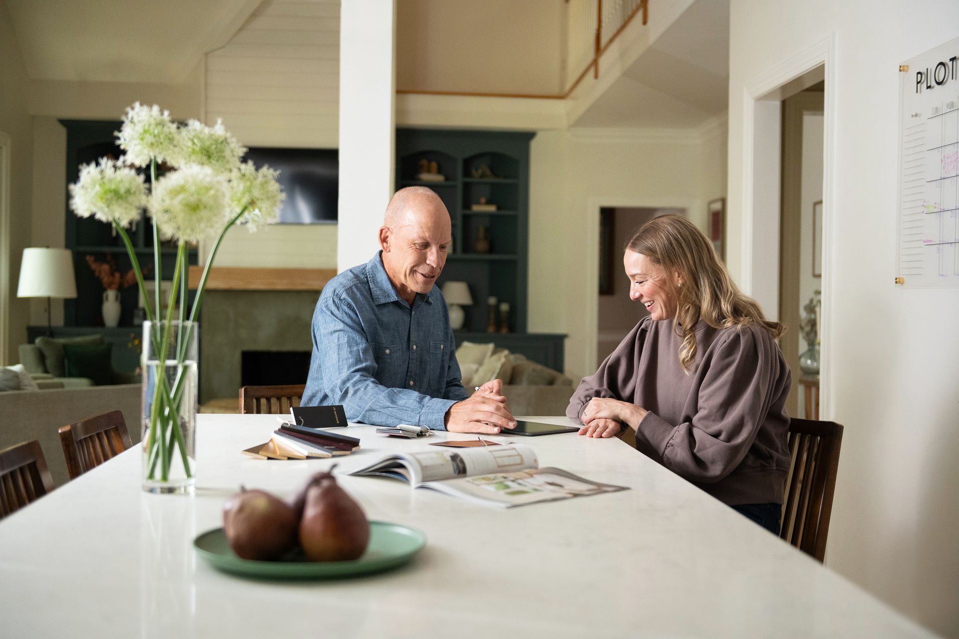 A black folding glass door is open to a living room.