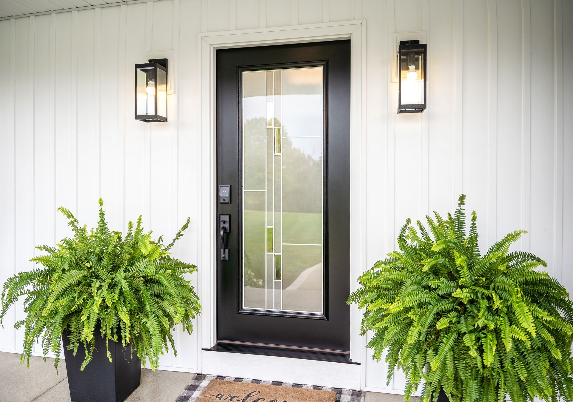 There are two potted plants in front of the door.