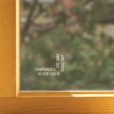 A close up of a window with a wooden frame and tempered glass.