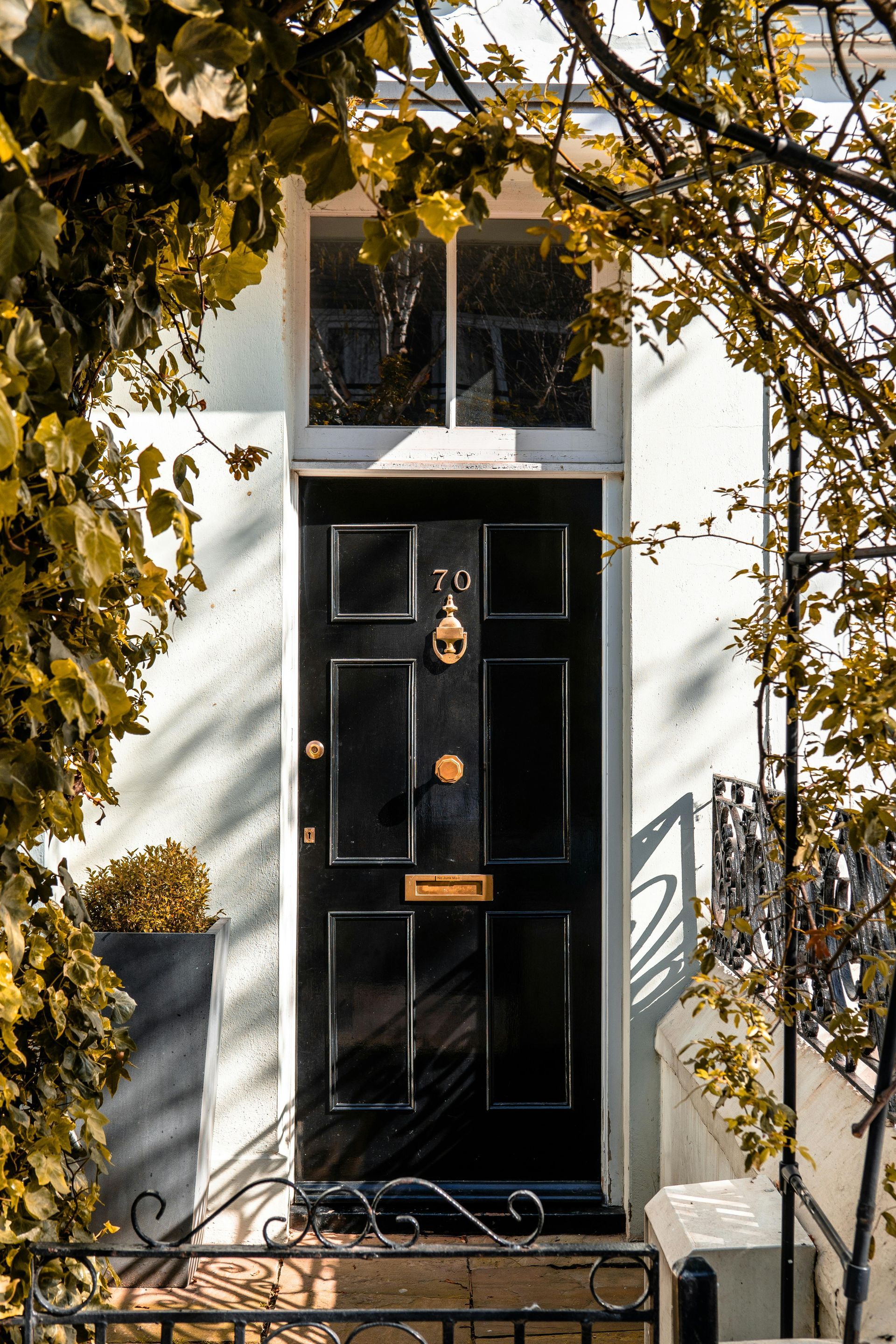 A black folding glass door is open to a living room.