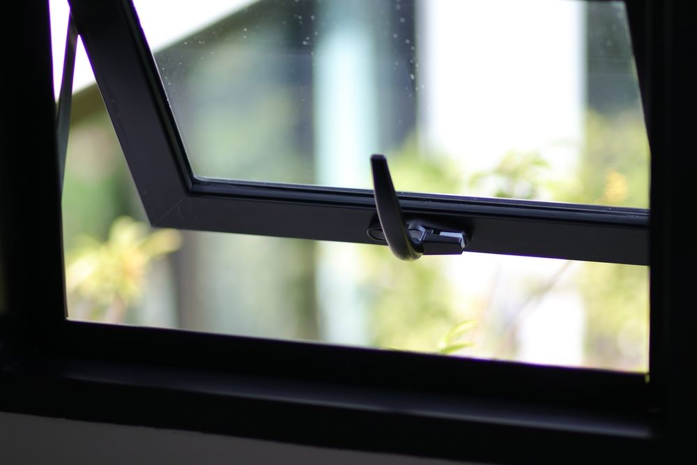 A close up of an open window with a black frame