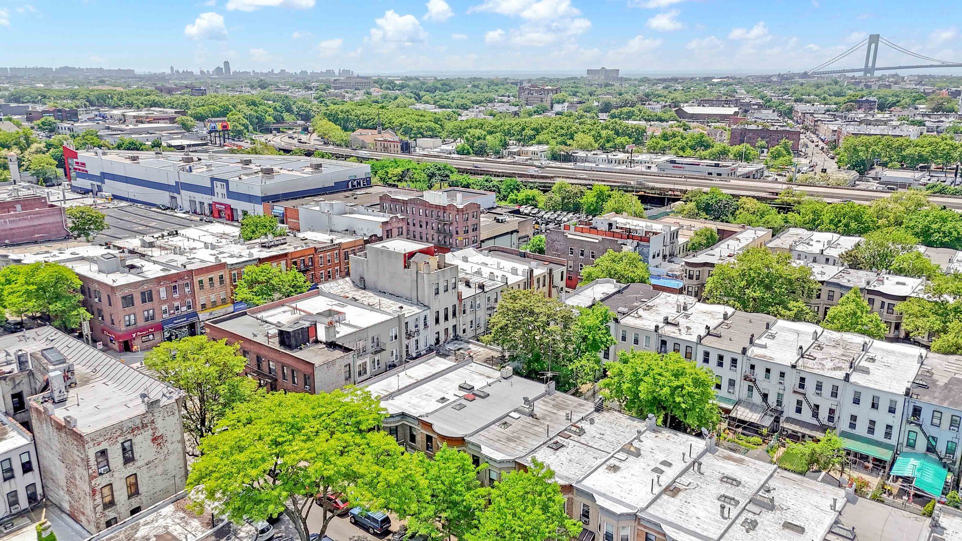 An aerial view of a city with lots of buildings and trees.