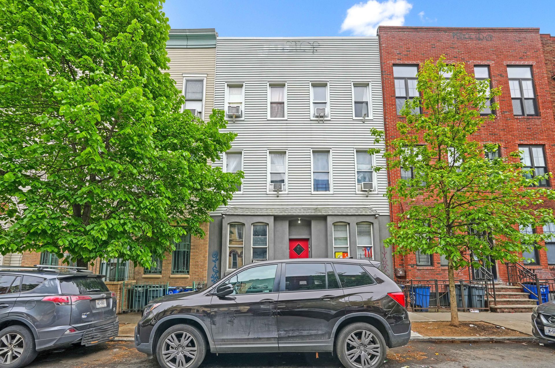 A black suv is parked in front of a building.