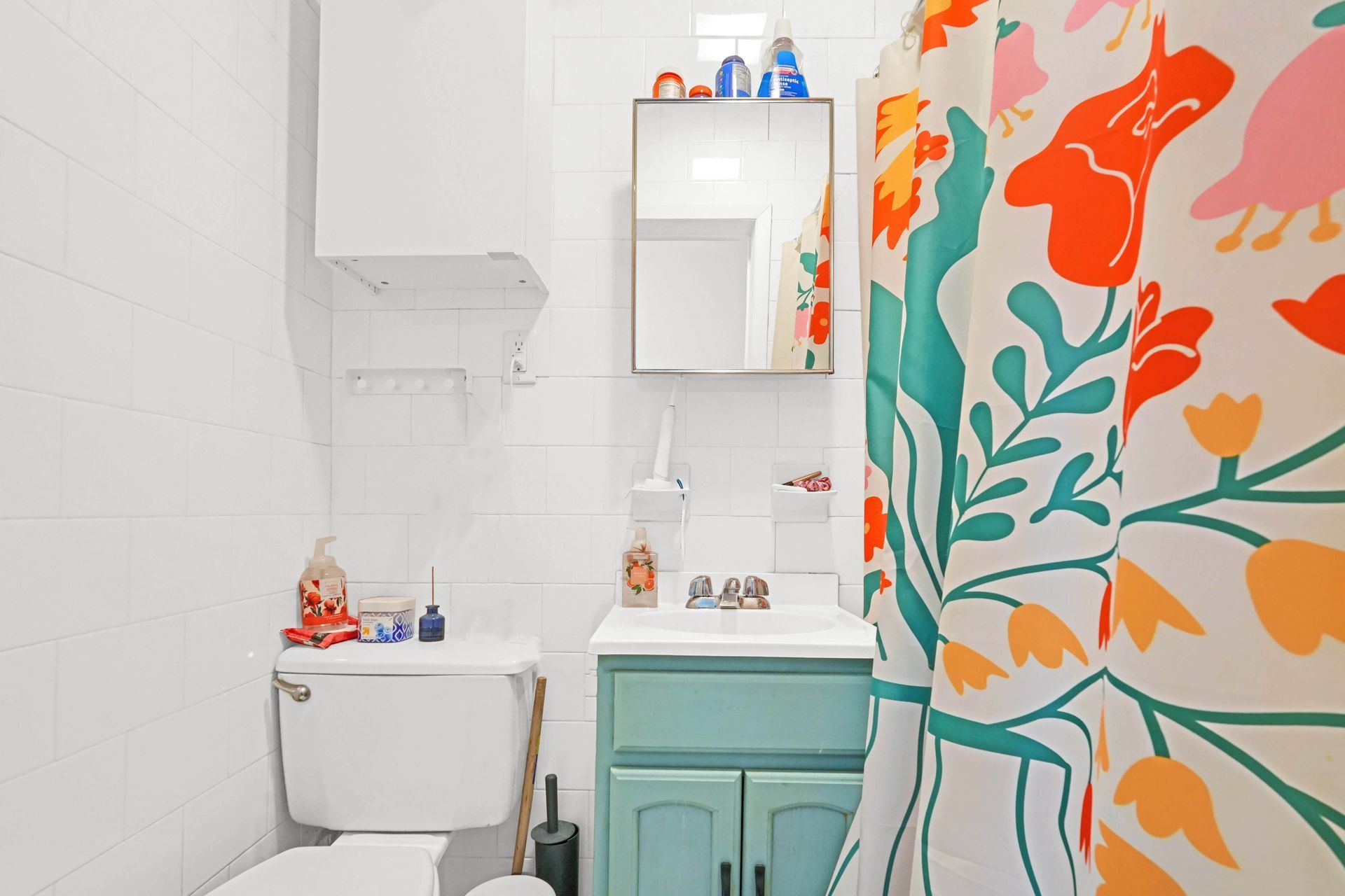 A bathroom with a toilet , sink and shower curtain