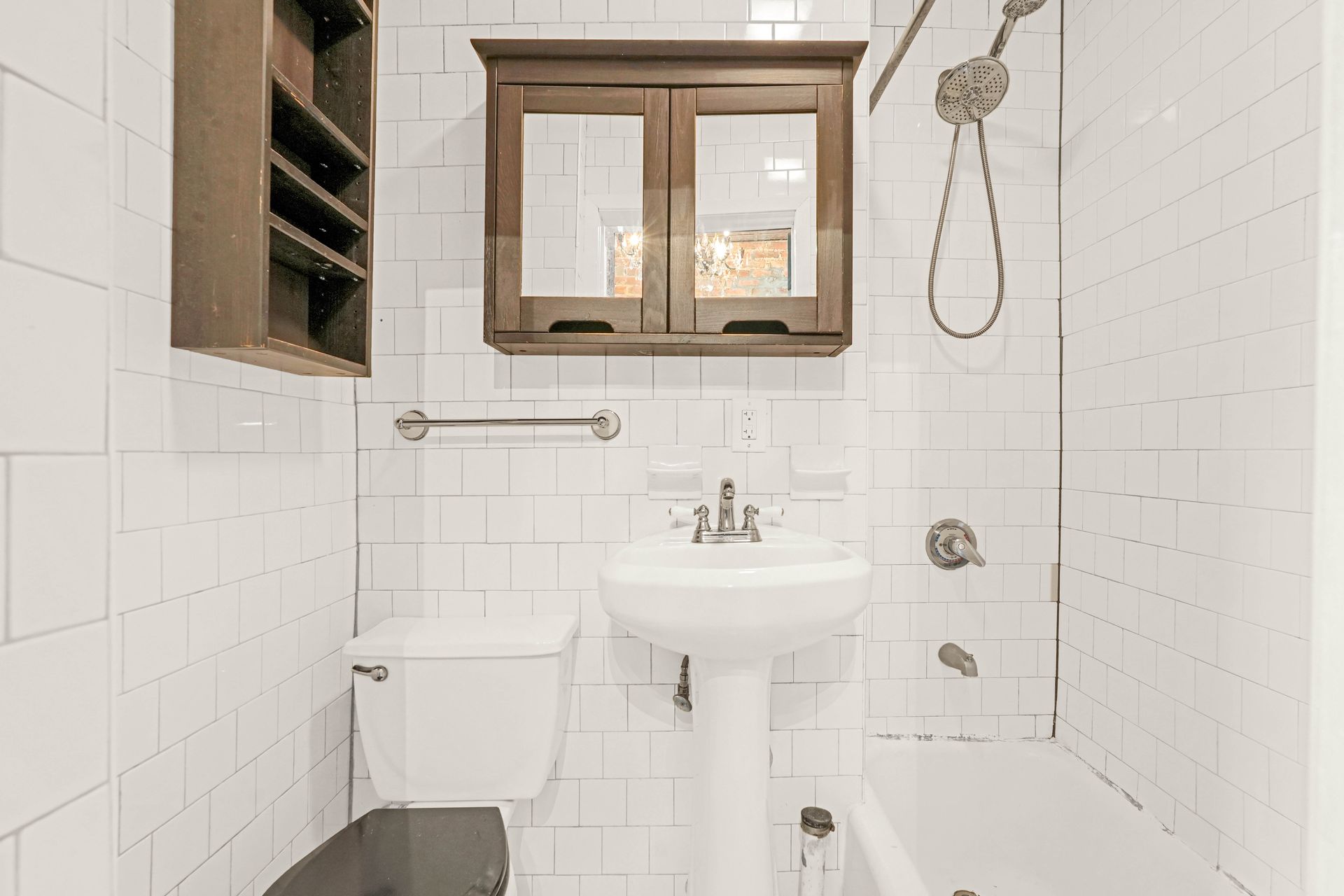 A bathroom with a toilet , sink , and bathtub.
