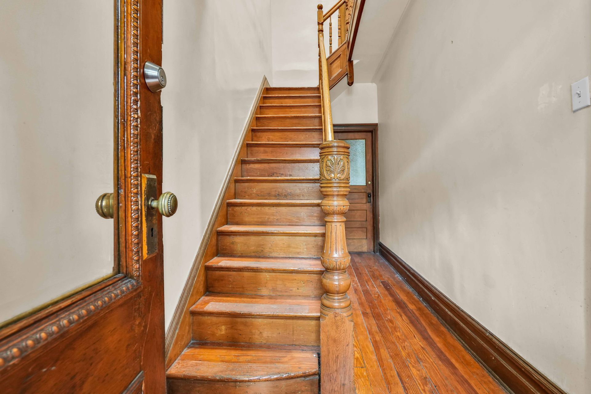 A wooden staircase leading up to the second floor of a house.